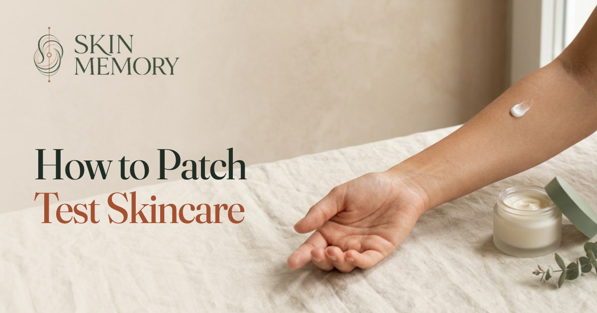 A forearm resting on linen with a small dab of moisturiser on the inner arm beside an open cream jar, illustrating how to patch test skincare